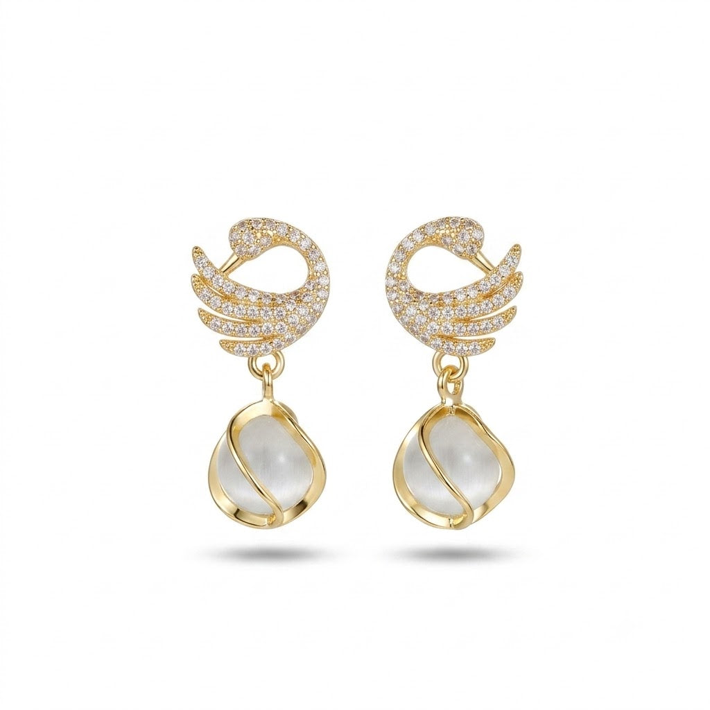 Elegant gold-tone drop earrings with pearly white pendant
